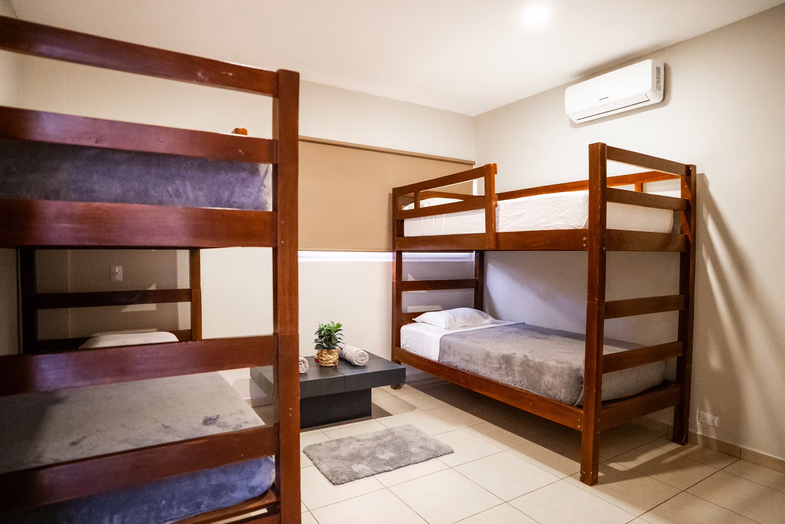 Two wooden bunk beds in bedroom five