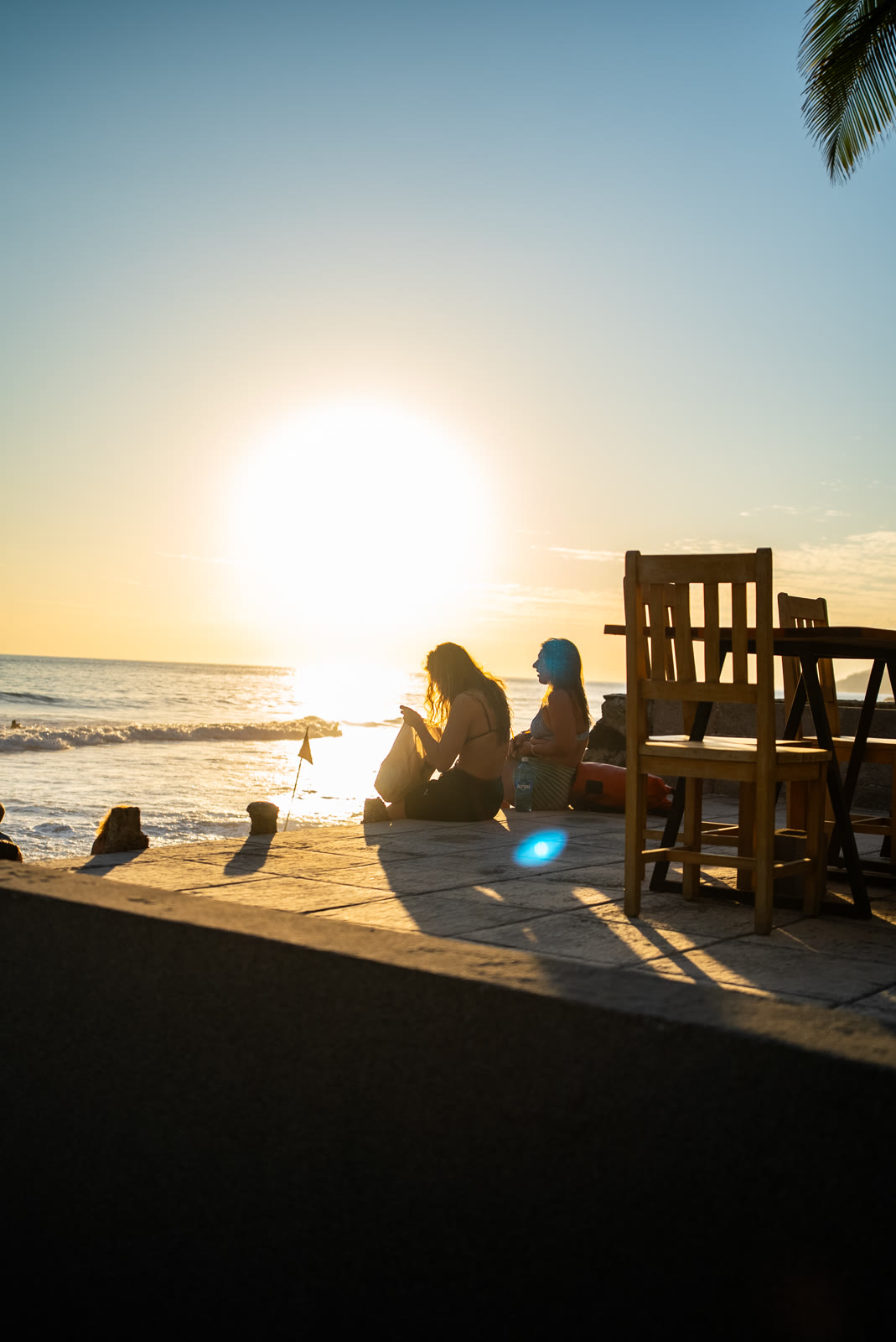 Guests watching the sunset by the ocean